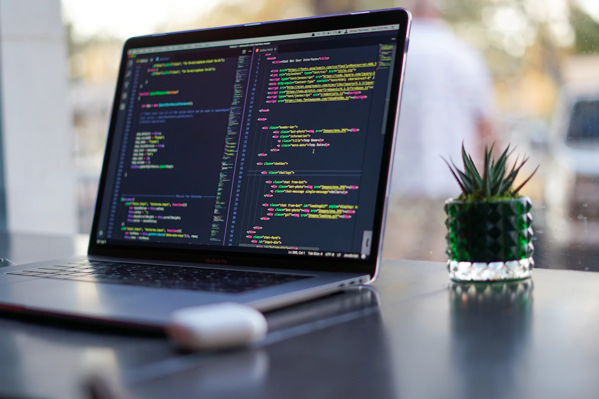 Demo photo: a laptop showing code on a desk