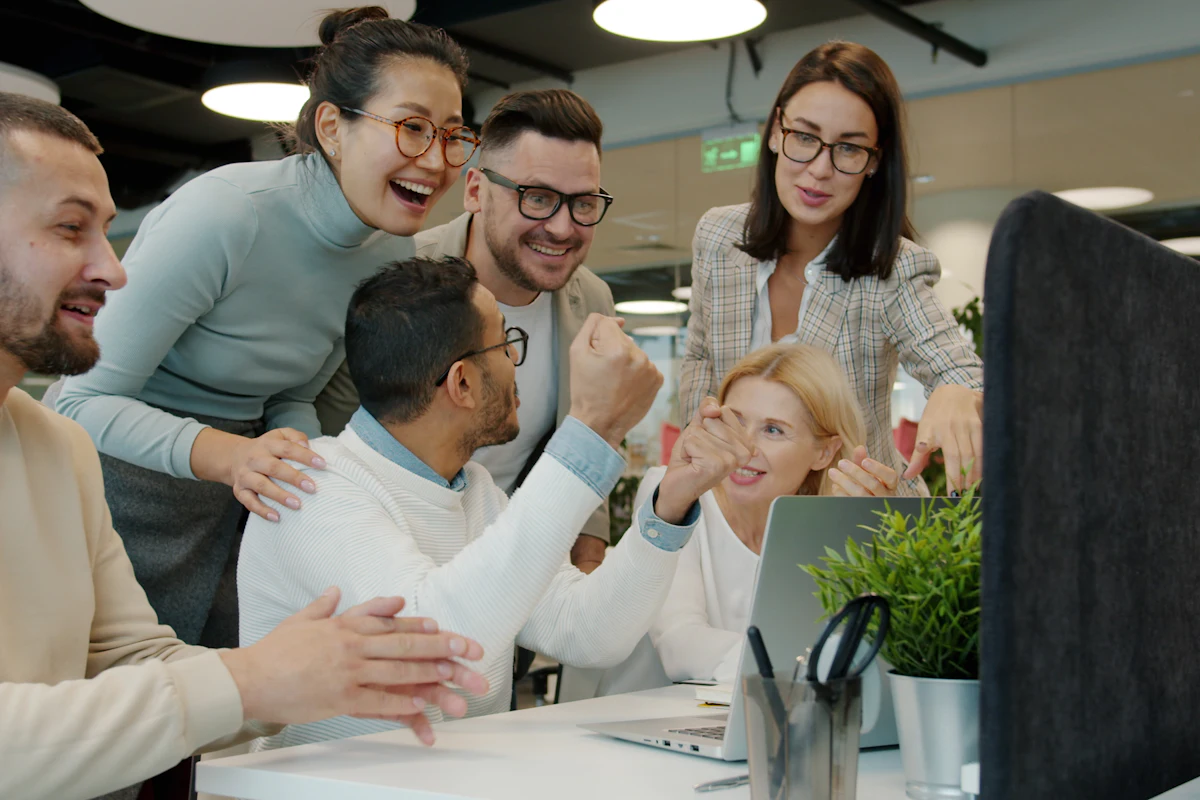 Demo photo: a team celebrating together at a desk