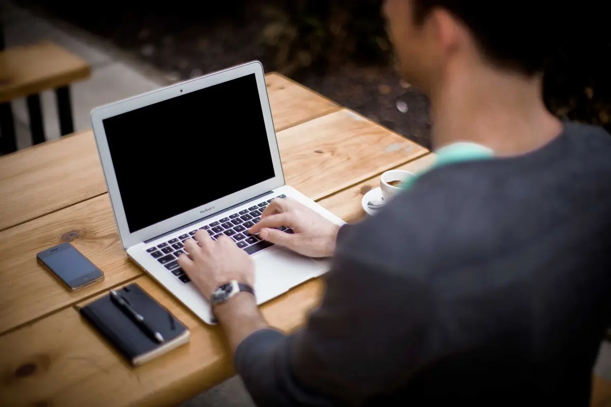 Demo photo: someone typing on a laptop
